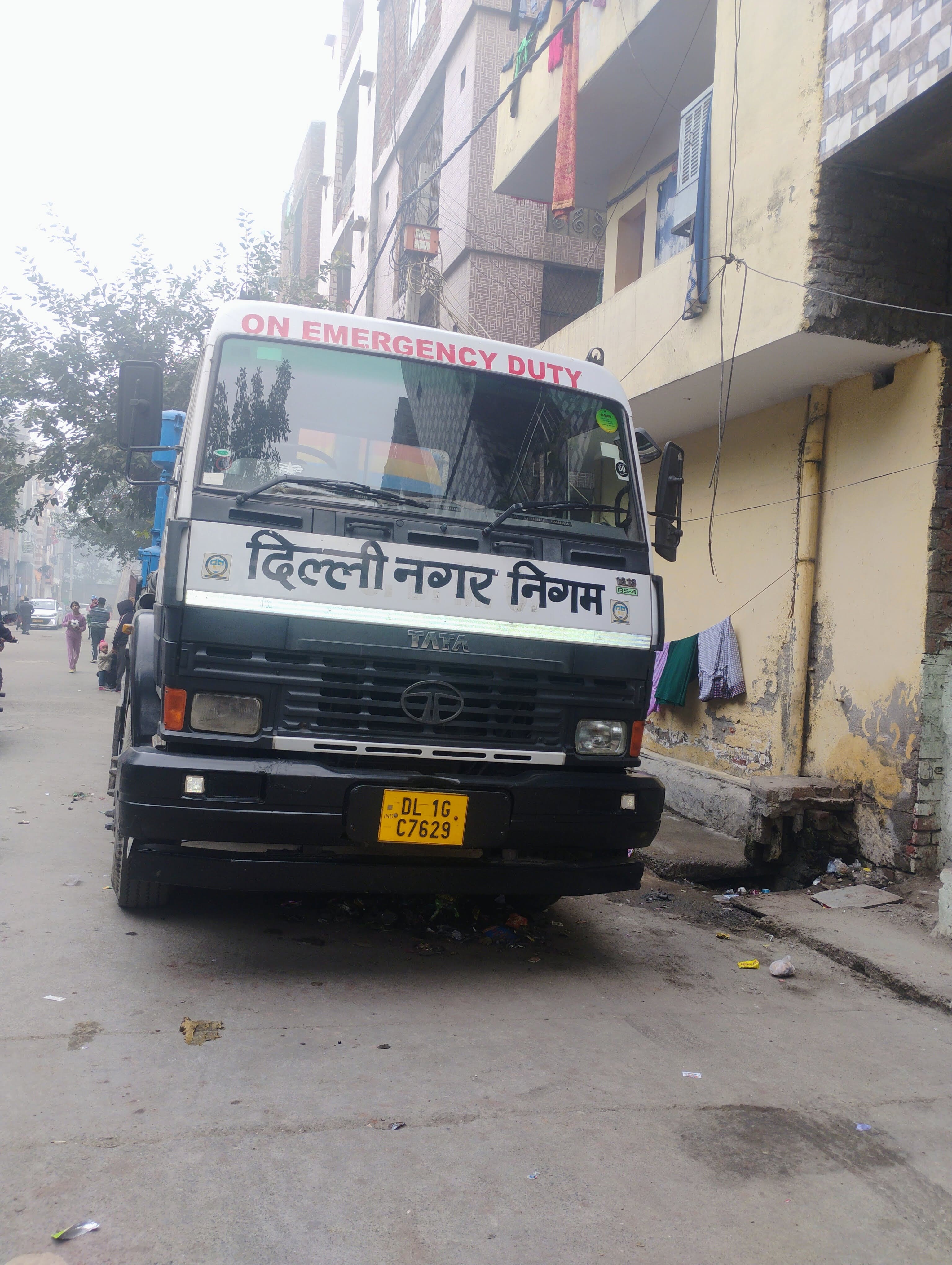 Residents standing in a Delhi lane during a neighborhood outreach effort.